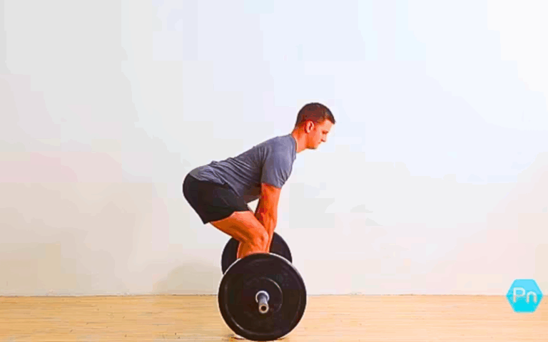 Athlete performing sumo deadlift with wide stance to target glutes, hamstrings, and inner thighs