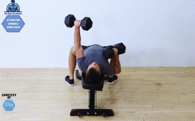 Certified personal trainer demonstrating the alternating dumbbell bench press.