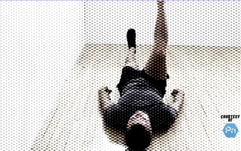 Personal trainer demonstrating the legs-only version of the dead bug exercise.