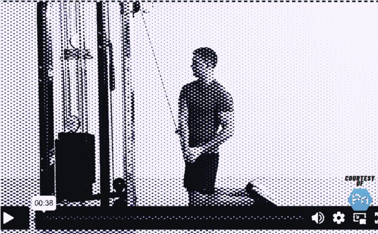 Personal trainer demonstrating the tall-kneeling cable chop exercise for core strength