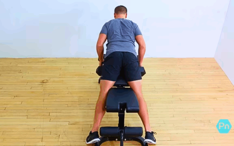 Athlete performing chest-supported dumbbell row to target upper back muscles with strict form