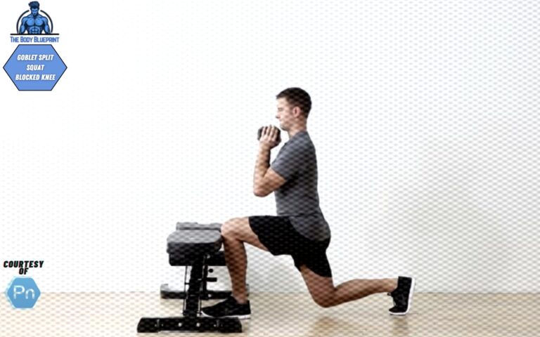 Certified personal trainer executing goblet split squat with blocked knee.