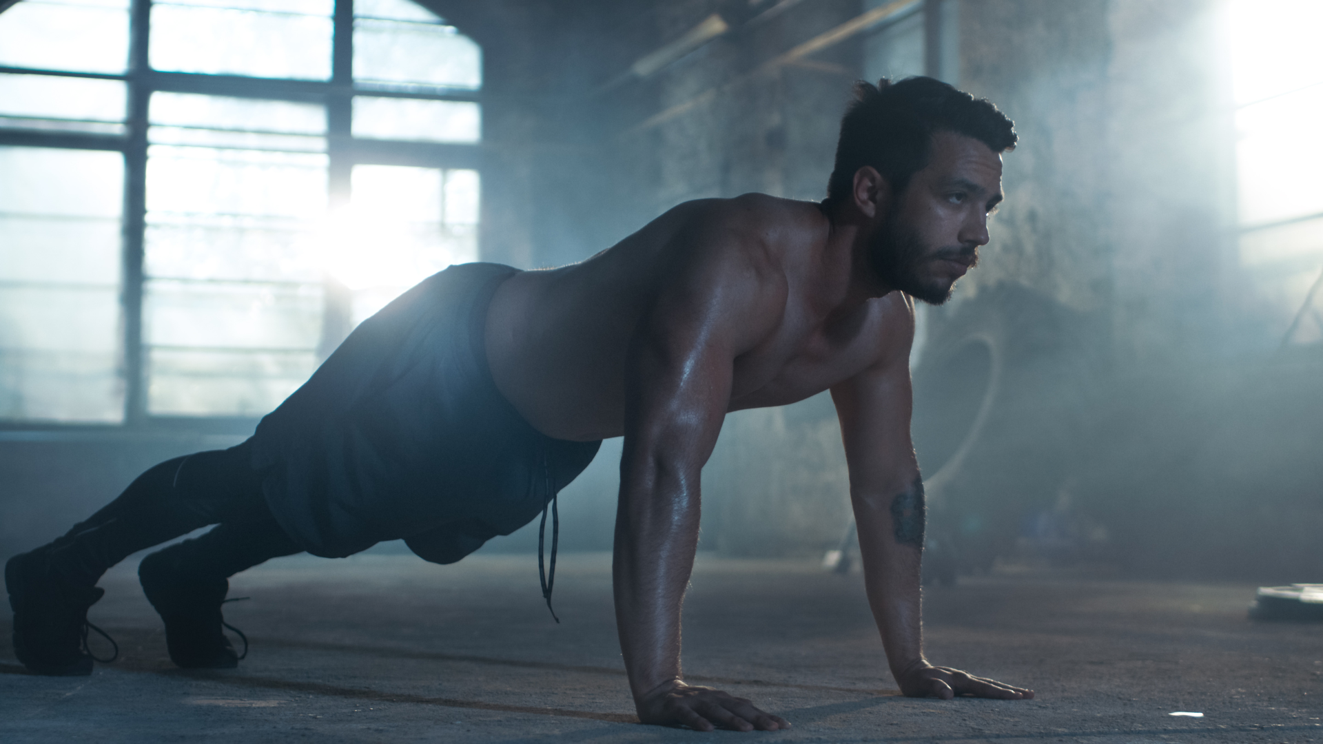 A man performing pushups intensely.