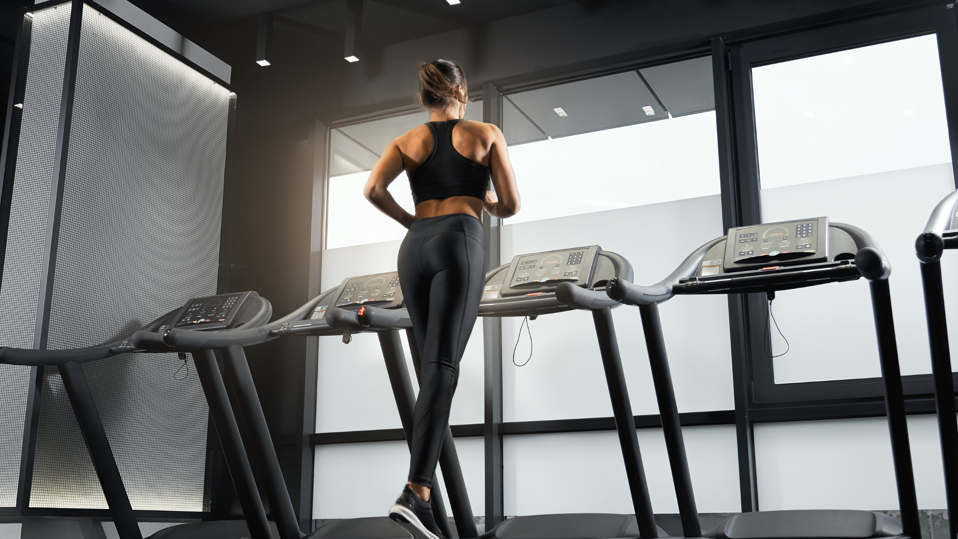 A fit woman running on a treadmill.
