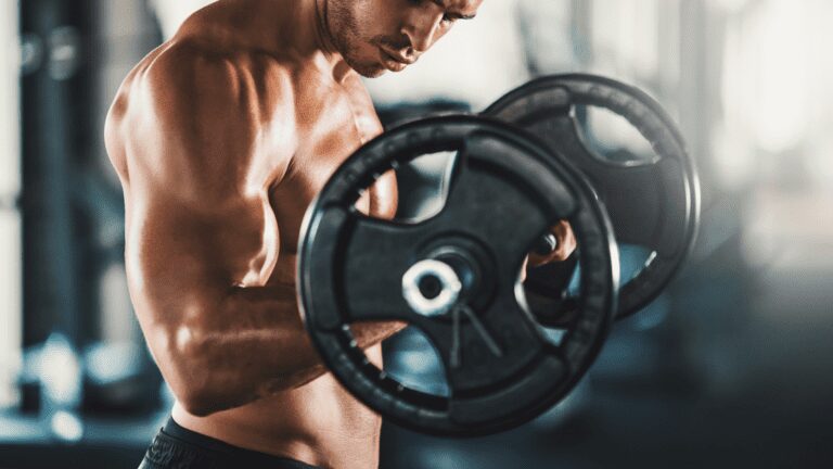 A focused man, displaying impeccable form while performing a barbell curl. His stance is firm, muscles engaged and eyes determined, showcasing the perfect execution of strength training.