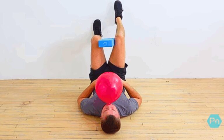 Athlete performing 90/90 wall balloon-breathing for core activation and diaphragmatic control
