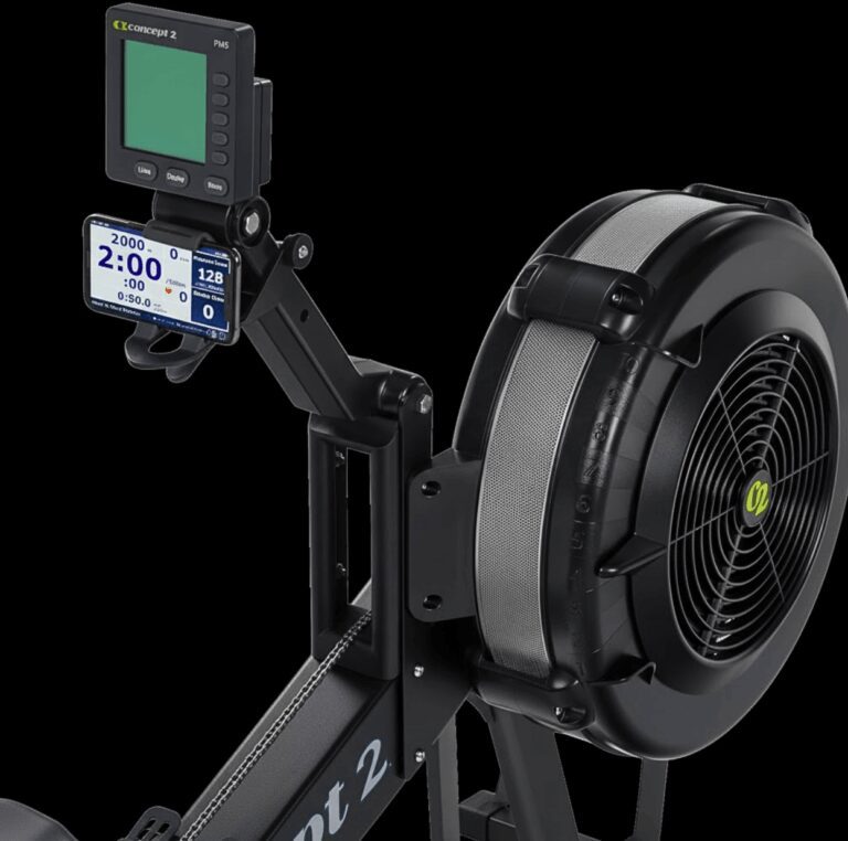 Technical close-up of the Concept2 PM5 performance monitor mounted on a RowErg, displaying high-contrast training metrics including split time, stroke rate, and Bluetooth-connected heart rate data for precise metabolic conditioning.