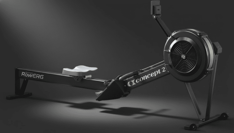 Technical breakdown of the Concept2 RowErg assembly points, showing the PM5 monitor mounting arm, the flywheel-to-monorail connection point, and the adjustable footrest assembly for proper machine calibration.