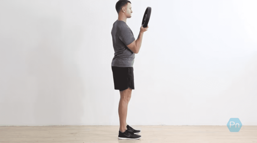 Lifter performing a pinch grip plate curl