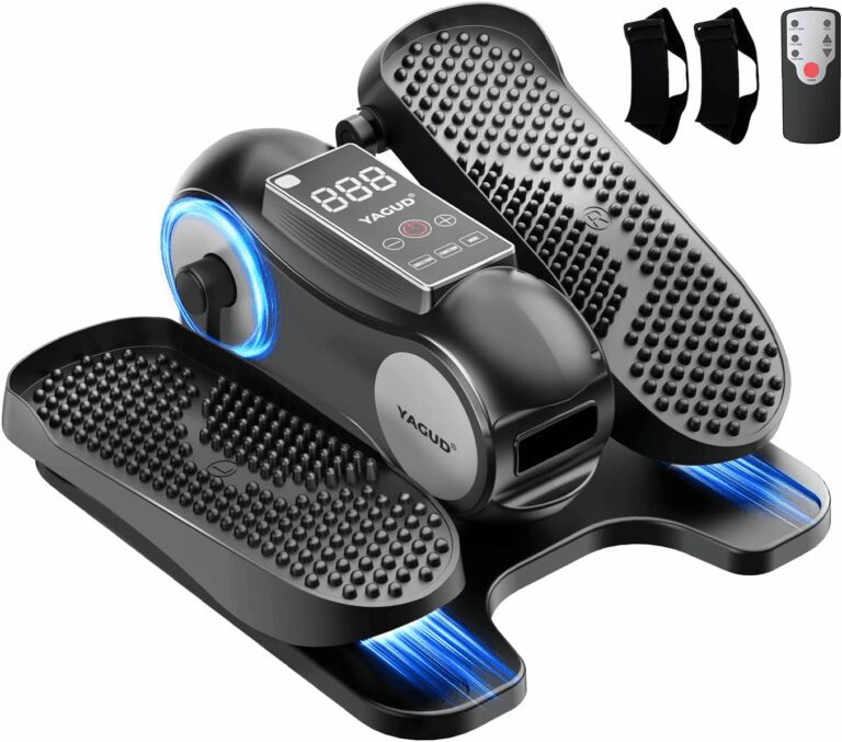 Black YAGUD under-desk elliptical machine displaying textured foot pedals, a digital tracking monitor, two resistance straps, and a remote control, verifying its compact seated workout design for the review.