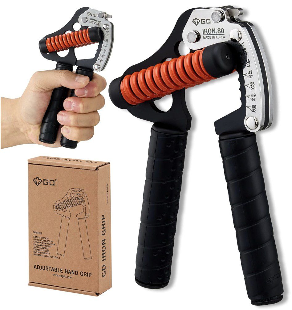GD Iron.80 Adjustable Hand Grip A GD Iron.80 adjustable hand strengthener featuring black textured handles, a thick orange tension spring, and a silver metal frame with a printed resistance scale. The image also shows a person's hand squeezing the device and the product's brown cardboard packaging box.